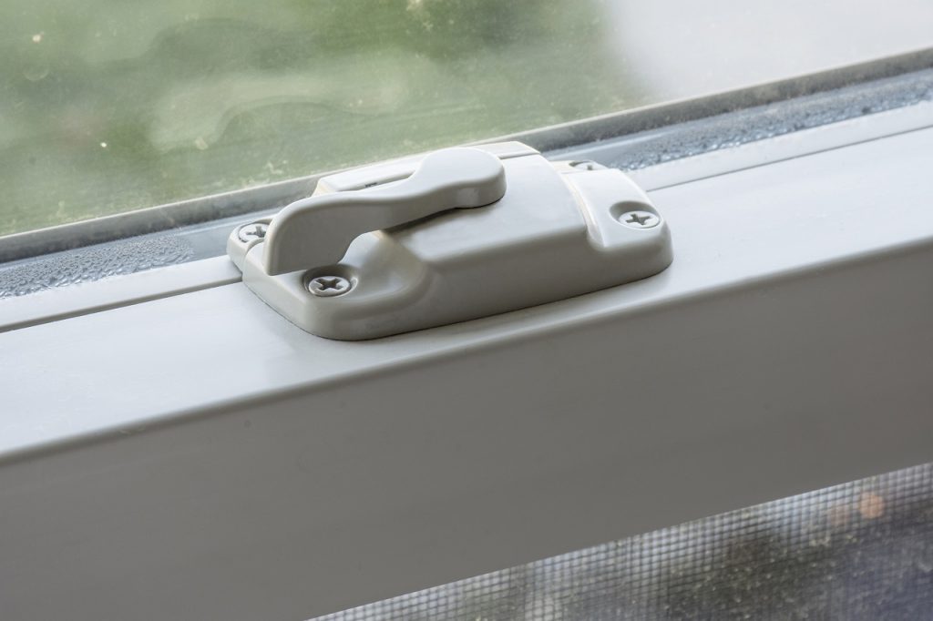 A lock or latch on a window in a home.